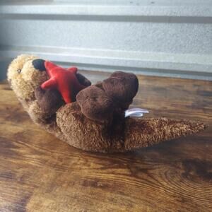 Aurora Sea Otter Plush Holding Red Star Fish Stuffed Animal Brown Toy